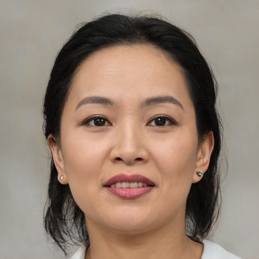 Joyful asian young-adult female with medium  brown hair and brown eyes