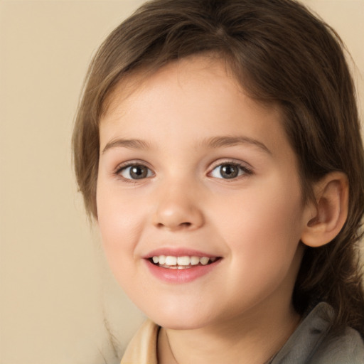 Joyful white child female with medium  brown hair and brown eyes