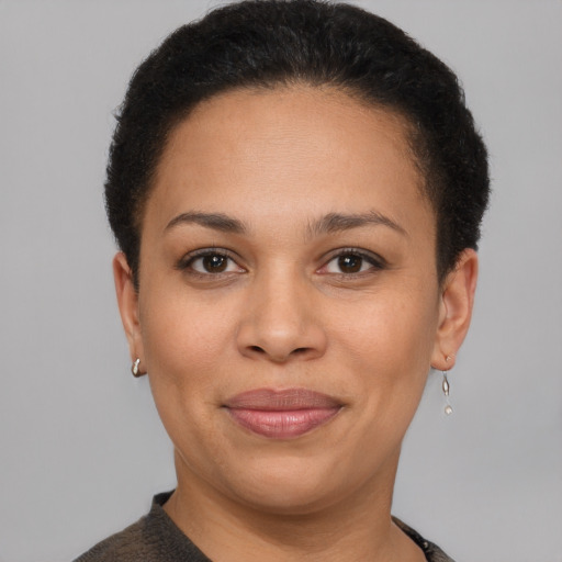 Joyful latino adult female with short  brown hair and brown eyes