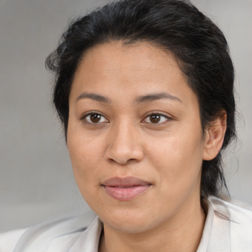 Joyful latino adult female with medium  brown hair and brown eyes