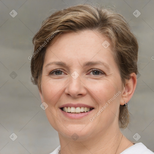 Joyful white adult female with medium  brown hair and grey eyes