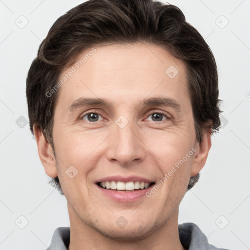 Joyful white adult male with short  brown hair and grey eyes