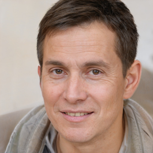 Joyful white adult male with short  brown hair and brown eyes