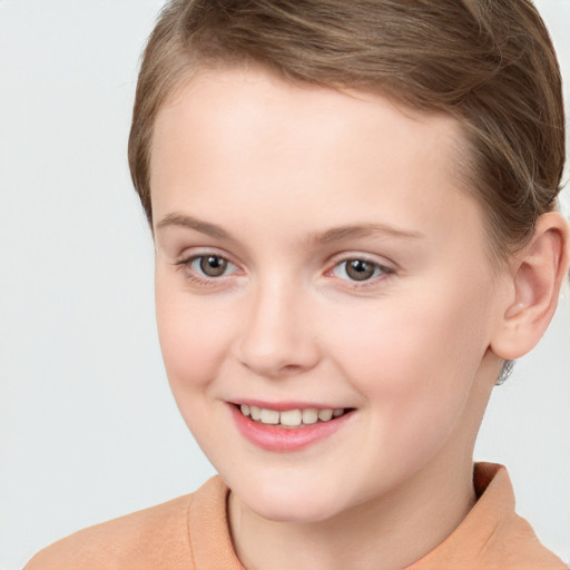 Joyful white child female with short  brown hair and brown eyes