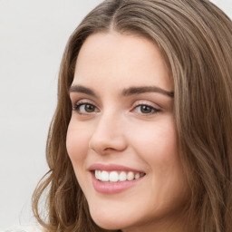 Joyful white young-adult female with long  brown hair and green eyes