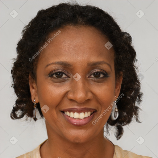 Joyful black adult female with medium  brown hair and brown eyes