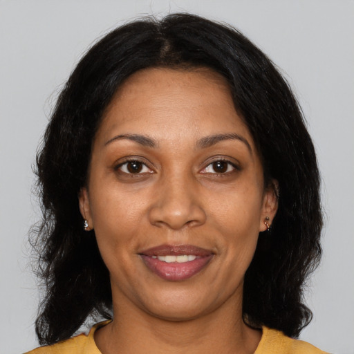 Joyful black adult female with medium  black hair and brown eyes