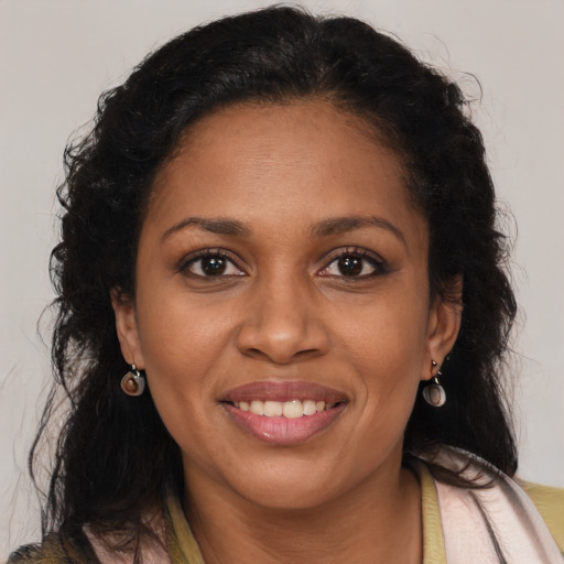 Joyful latino adult female with medium  brown hair and brown eyes