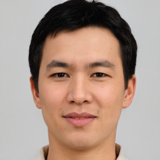Joyful asian young-adult male with short  black hair and brown eyes