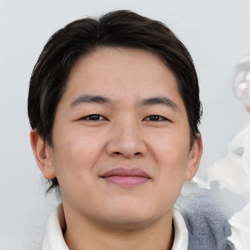 Joyful asian young-adult male with short  brown hair and brown eyes