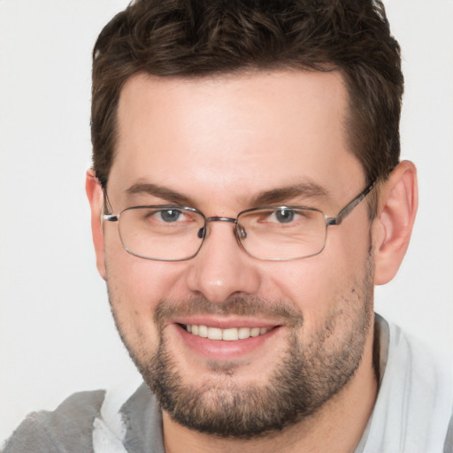 Joyful white adult male with short  brown hair and brown eyes