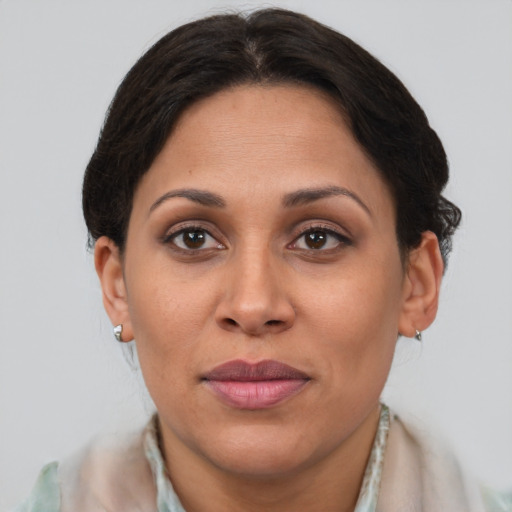 Joyful latino adult female with short  brown hair and brown eyes