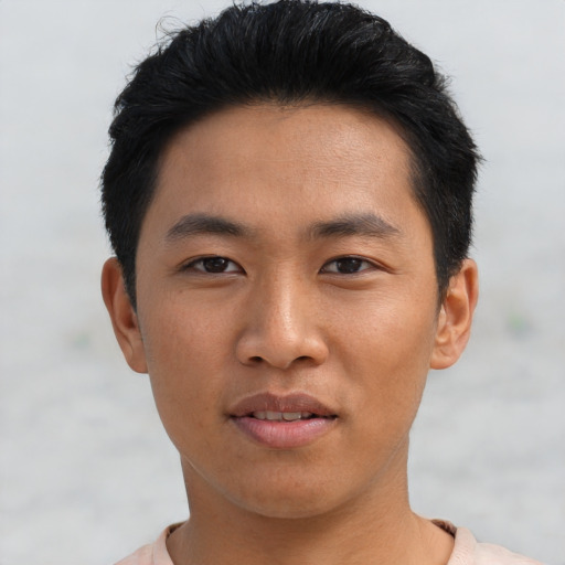 Joyful asian young-adult male with short  black hair and brown eyes