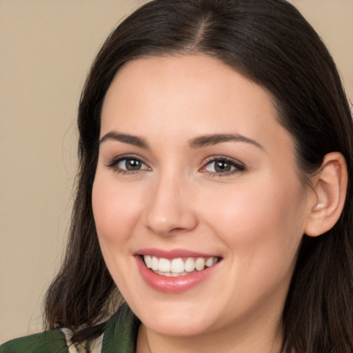 Joyful white young-adult female with long  brown hair and brown eyes