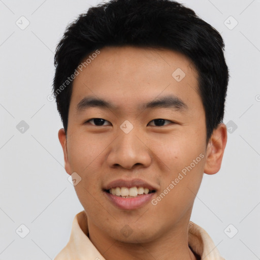 Joyful asian young-adult male with short  black hair and brown eyes