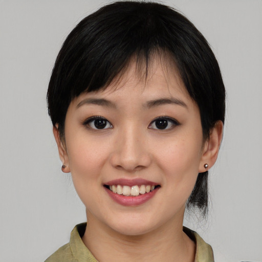 Joyful asian young-adult female with medium  black hair and brown eyes