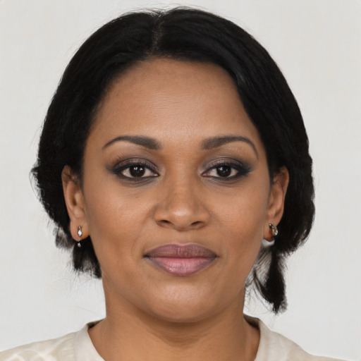 Joyful black young-adult female with medium  black hair and brown eyes