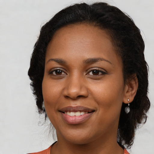 Joyful black young-adult female with medium  brown hair and brown eyes