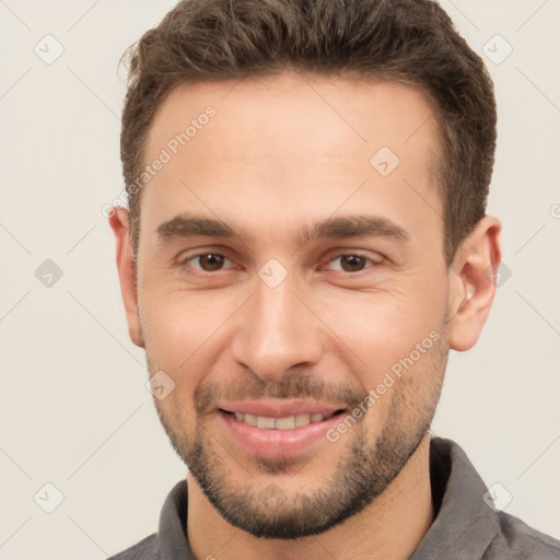 Joyful white young-adult male with short  brown hair and brown eyes