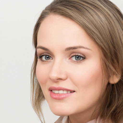 Joyful white young-adult female with long  brown hair and grey eyes