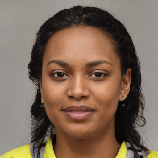 Joyful black young-adult female with medium  black hair and brown eyes