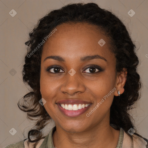 Joyful black young-adult female with long  brown hair and brown eyes