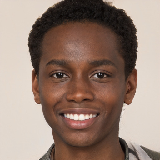 Joyful black young-adult male with short  brown hair and brown eyes