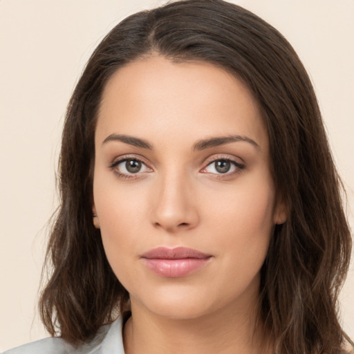 Neutral white young-adult female with long  brown hair and brown eyes