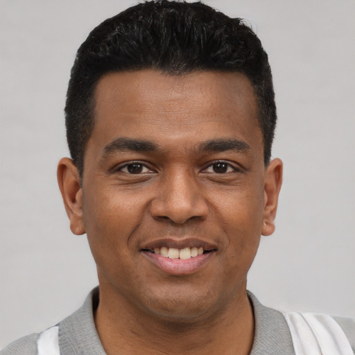 Joyful latino young-adult male with short  black hair and brown eyes