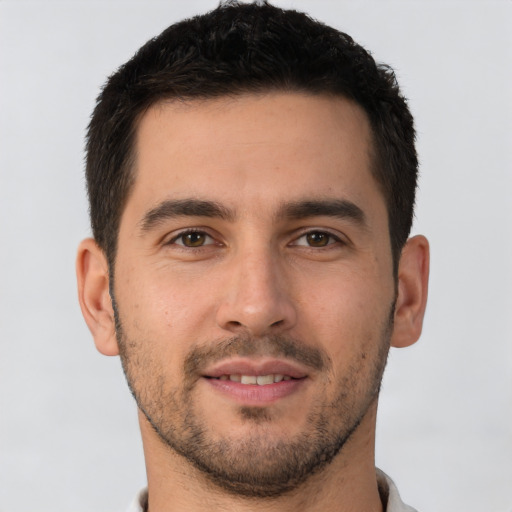 Joyful white young-adult male with short  brown hair and brown eyes