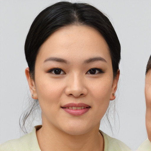 Joyful asian young-adult female with medium  brown hair and brown eyes