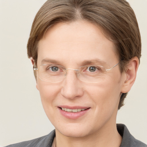 Joyful white adult female with short  brown hair and grey eyes