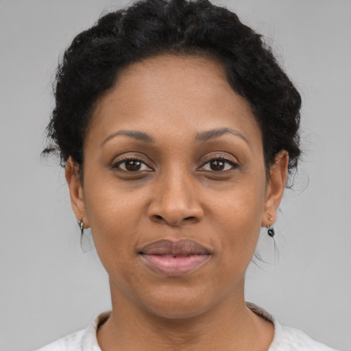 Joyful black adult female with short  black hair and brown eyes