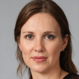 Joyful white adult female with medium  brown hair and grey eyes