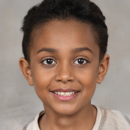 Joyful black child female with short  brown hair and brown eyes