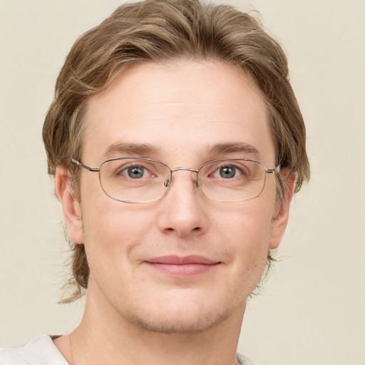 Joyful white adult male with short  brown hair and green eyes