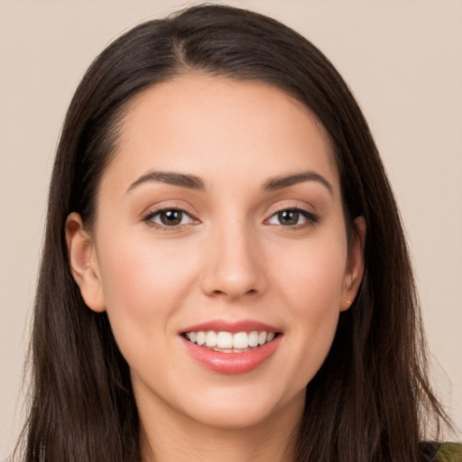 Joyful white young-adult female with long  brown hair and brown eyes