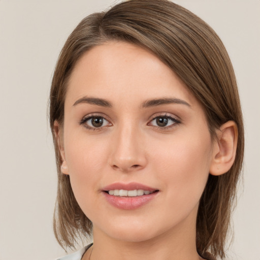 Joyful white young-adult female with medium  brown hair and brown eyes