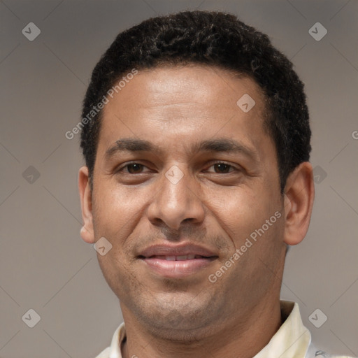 Joyful latino adult male with short  brown hair and brown eyes