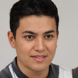 Joyful latino young-adult male with short  brown hair and brown eyes