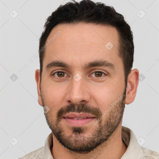 Joyful white young-adult male with short  brown hair and brown eyes