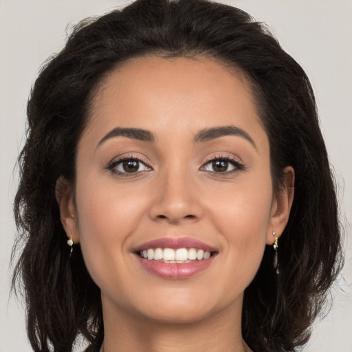 Joyful white young-adult female with long  brown hair and brown eyes