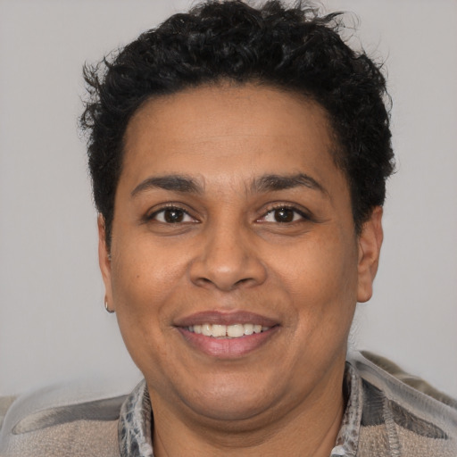 Joyful latino adult male with short  brown hair and brown eyes