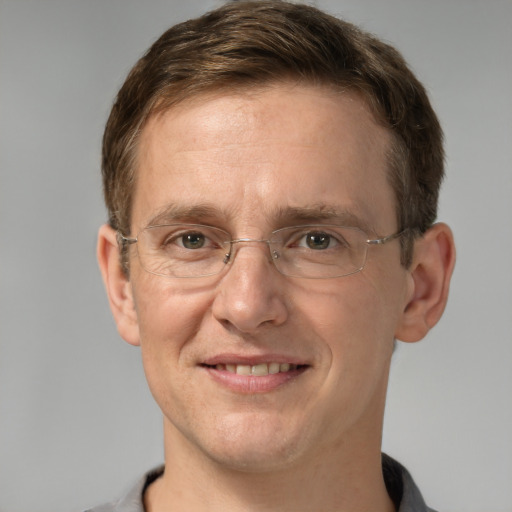 Joyful white adult male with short  brown hair and grey eyes