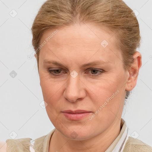 Joyful white adult female with medium  brown hair and blue eyes