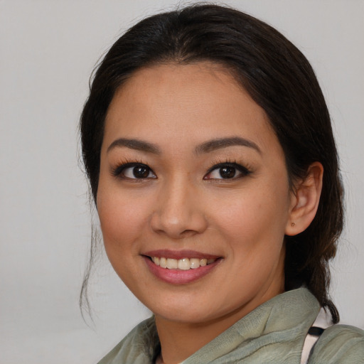 Joyful white young-adult female with medium  brown hair and brown eyes