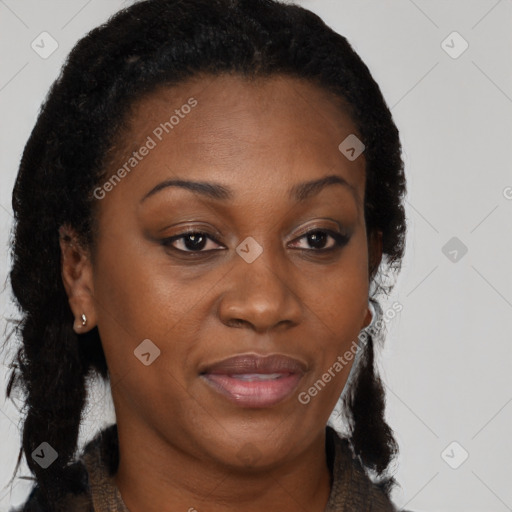 Joyful black adult female with long  brown hair and brown eyes