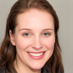 Joyful white young-adult female with long  brown hair and blue eyes