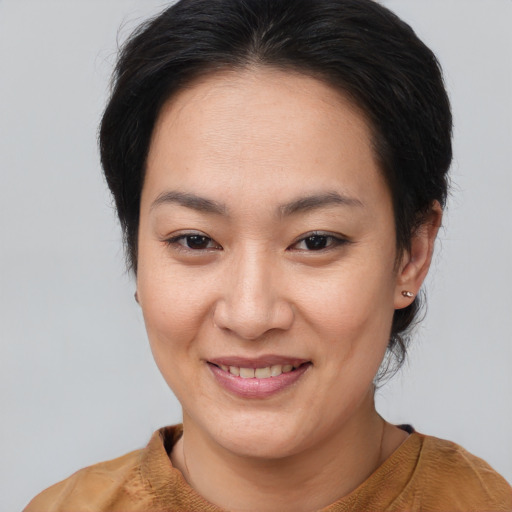 Joyful asian young-adult female with medium  brown hair and brown eyes