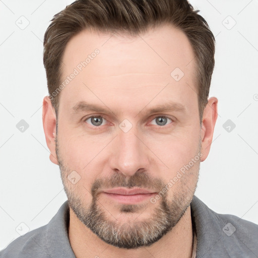 Joyful white adult male with short  brown hair and grey eyes